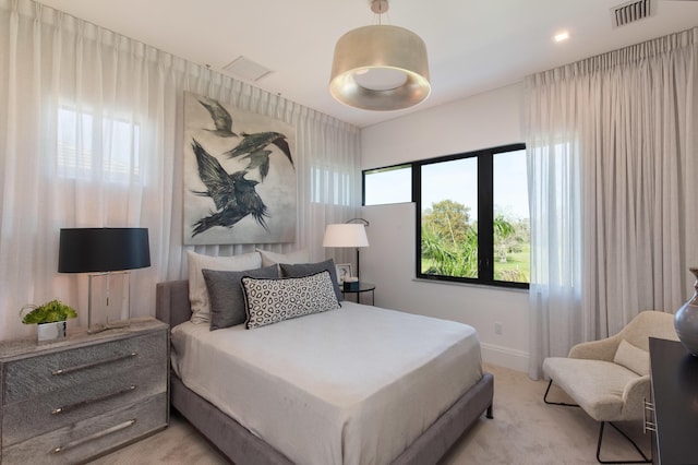 bedroom featuring light colored carpet, baseboards, and visible vents