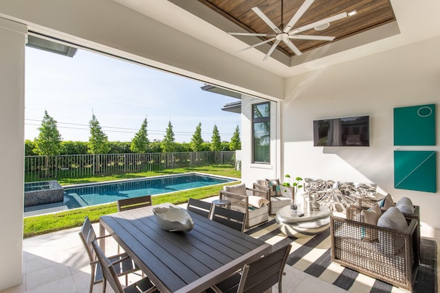 view of patio with ceiling fan, a fenced backyard, a fenced in pool, and outdoor dining space