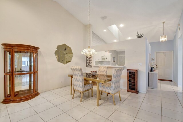 dining area with visible vents, high vaulted ceiling, light tile patterned floors, and a notable chandelier