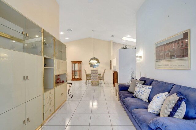 living area featuring visible vents, high vaulted ceiling, an inviting chandelier, and light tile patterned flooring