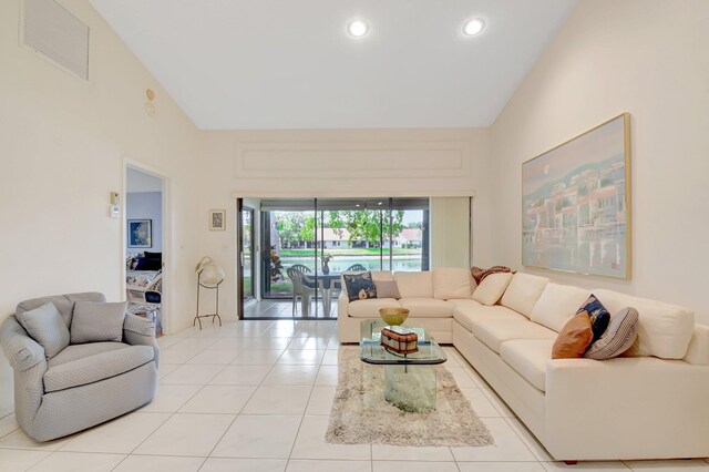 living room featuring light tile patterned floors, recessed lighting, visible vents, and high vaulted ceiling