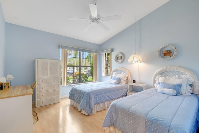bedroom with ceiling fan, vaulted ceiling, and wood finished floors