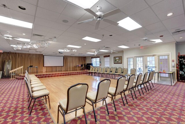miscellaneous room with carpet, visible vents, ceiling fan, and a drop ceiling
