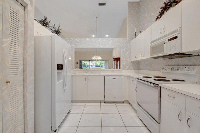 kitchen featuring white appliances, light tile patterned floors, light countertops, a sink, and visible vents