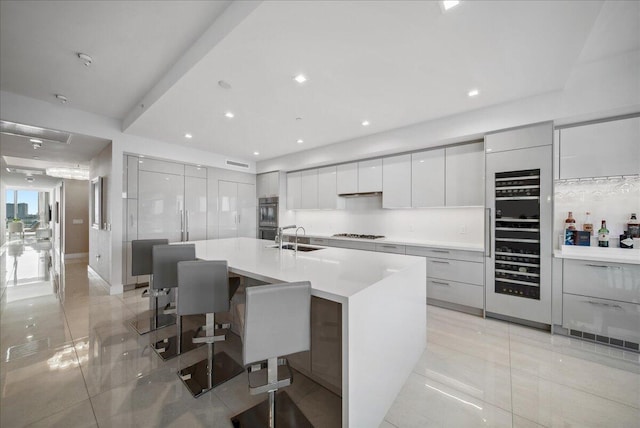 5000 N Ocean Dr Unit 603, Singer Island, FL 33404 - kitchen featuring a sink, beverage cooler, gas stovetop, modern cabinets, and light countertops