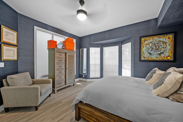 11851 Pebblewood Dr, Wellington, FL 33414 - bedroom featuring wallpapered walls, light wood-style flooring, baseboards, and ceiling fan