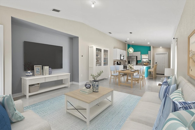 living area featuring light tile patterned floors and lofted ceiling