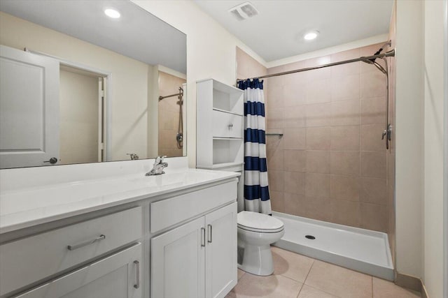 bathroom featuring tile patterned floors, tiled shower, toilet, vanity, and recessed lighting