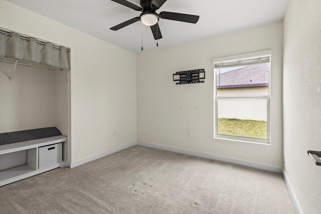 unfurnished bedroom with carpet, baseboards, and ceiling fan