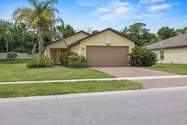 ranch-style home with an attached garage, decorative driveway, a front lawn, and stucco siding