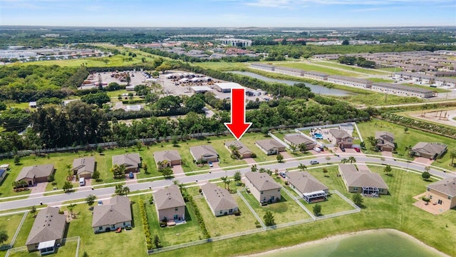 view of property location with a nearby body of water and nearby suburban area