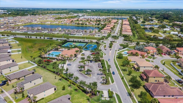 view of property location with nearby suburban area, a large body of water, and a pool