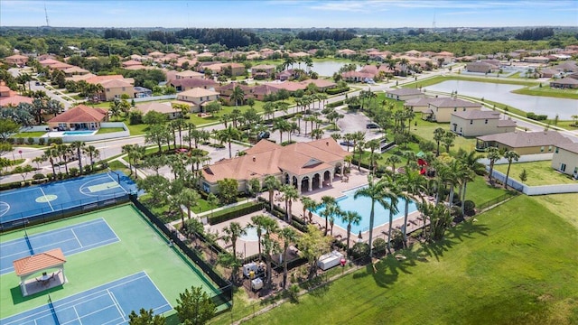 aerial view of residential area featuring a pool area and a large body of water
