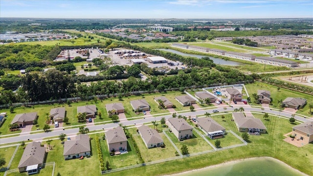 aerial overview of property's location with a nearby body of water and nearby suburban area