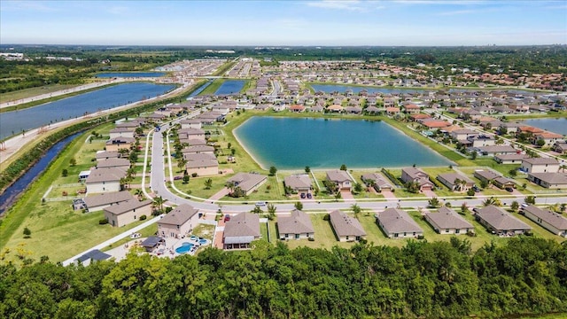 aerial view of property's location with nearby suburban area and a large body of water