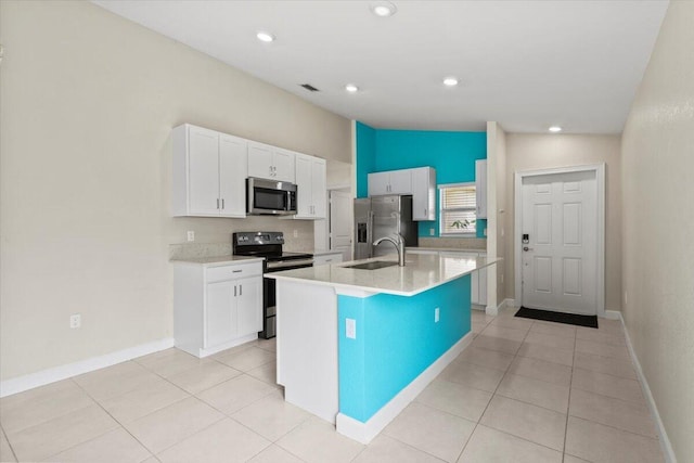 kitchen with appliances with stainless steel finishes, a sink, white cabinets, light countertops, and recessed lighting