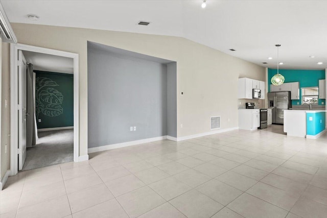 unfurnished living room featuring light tile patterned floors, vaulted ceiling, a sink, baseboards, and recessed lighting