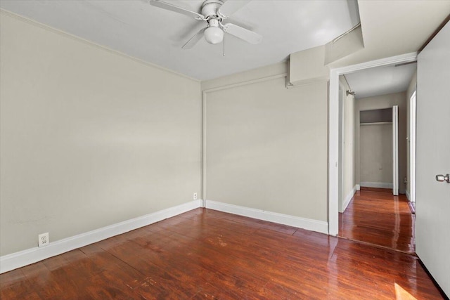 unfurnished bedroom with baseboards, wood finished floors, a closet, and ceiling fan