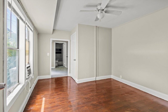 empty room with a ceiling fan, a healthy amount of sunlight, and wood finished floors