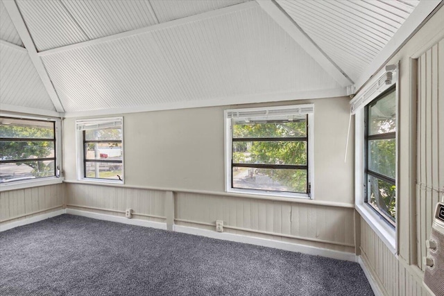 unfurnished sunroom featuring plenty of natural light, vaulted ceiling, and carpet floors