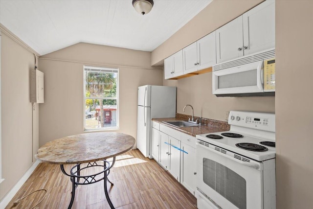 kitchen with a sink, light wood-type flooring, vaulted ceiling, white cabinetry, and white appliances