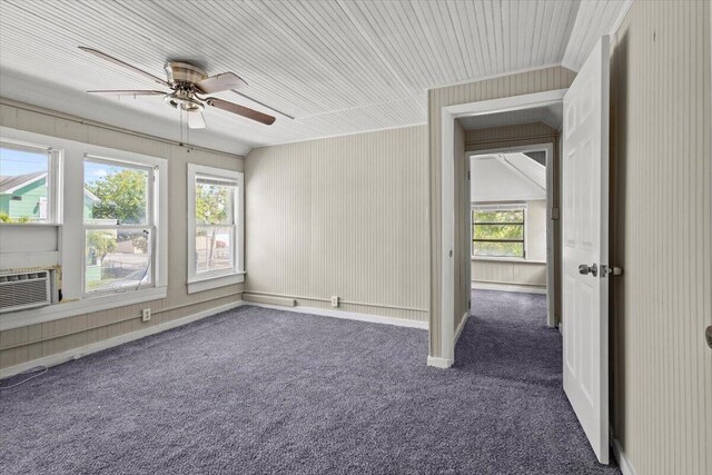 unfurnished room featuring a ceiling fan and dark colored carpet