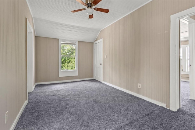 carpeted empty room featuring lofted ceiling and a ceiling fan