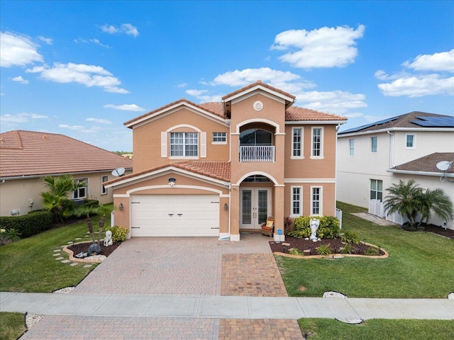 1018 NW Demedici Rd, Port Saint Lucie, FL 34986 - mediterranean / spanish home with french doors, stucco siding, a garage, decorative driveway, and a tile roof