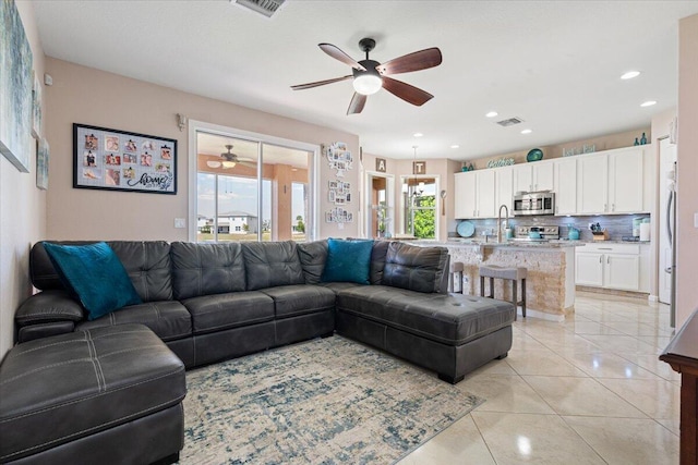 1018 NW Demedici Rd, Port Saint Lucie, FL 34986 - living room with a ceiling fan, light tile patterned floors, and recessed lighting