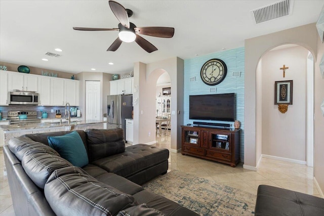 1018 NW Demedici Rd, Port Saint Lucie, FL 34986 - living room featuring arched walkways, a ceiling fan, light tile patterned flooring, baseboards, and recessed lighting