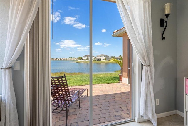 1018 NW Demedici Rd, Port Saint Lucie, FL 34986 - doorway to outside with a water view and baseboards