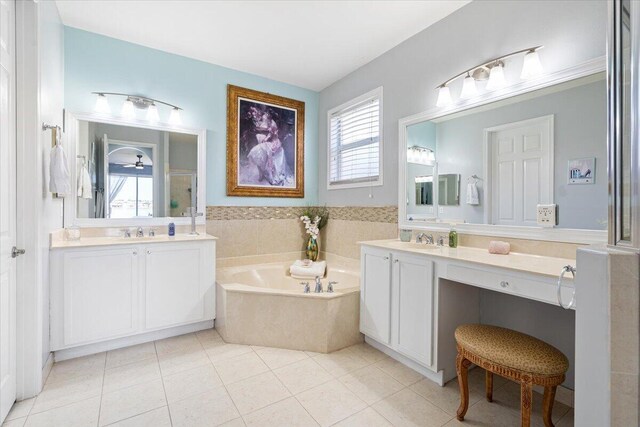 1018 NW Demedici Rd, Port Saint Lucie, FL 34986 - full bathroom with a garden tub, two vanities, and tile patterned flooring