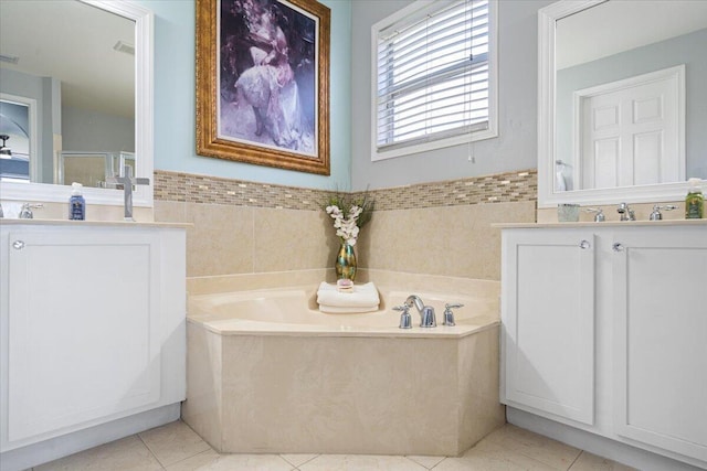 1018 NW Demedici Rd, Port Saint Lucie, FL 34986 - bathroom with tile patterned flooring, vanity, a bath, a stall shower, and tile walls