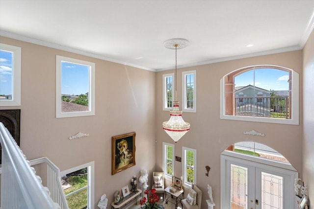 1018 NW Demedici Rd, Port Saint Lucie, FL 34986 - foyer entrance with a high ceiling, plenty of natural light, and crown molding