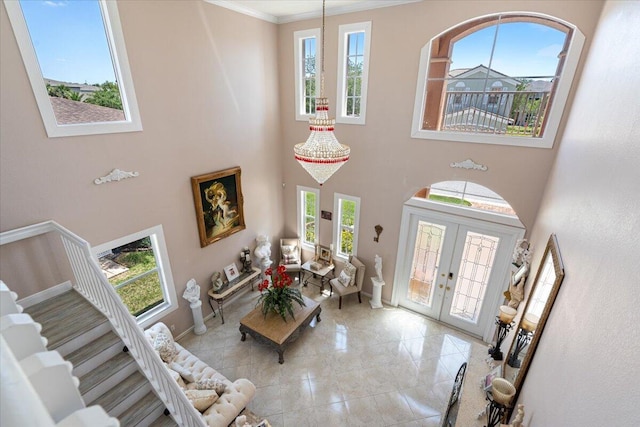 1018 NW Demedici Rd, Port Saint Lucie, FL 34986 - entrance foyer featuring a high ceiling, stairs, french doors, ornamental molding, and baseboards