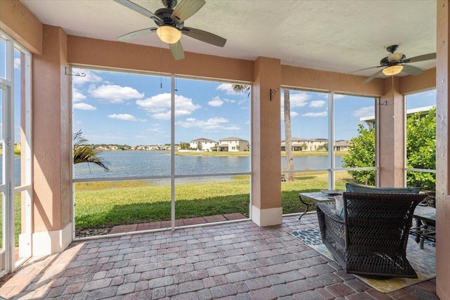 1018 NW Demedici Rd, Port Saint Lucie, FL 34986 - sunroom featuring a ceiling fan and a water view
