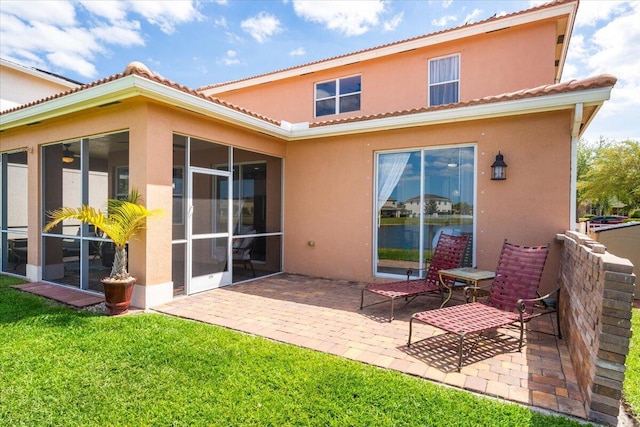1018 NW Demedici Rd, Port Saint Lucie, FL 34986 - rear view of house with a lawn, stucco siding, a patio, and a tiled roof