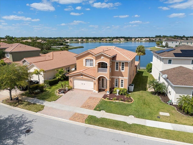 1018 NW Demedici Rd, Port Saint Lucie, FL 34986 - view of front facade with a tile roof, a water view, stucco siding, and decorative driveway