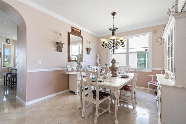 1018 NW Demedici Rd, Port Saint Lucie, FL 34986 - dining room featuring arched walkways, crown molding, baseboards, a chandelier, and light tile patterned floors