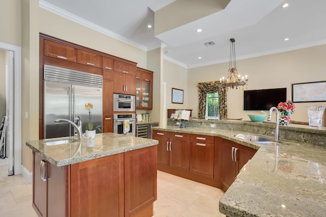 2409 NE 12th St, Fort Lauderdale, FL 33304 - kitchen with built in fridge, visible vents, a sink, and ornamental molding