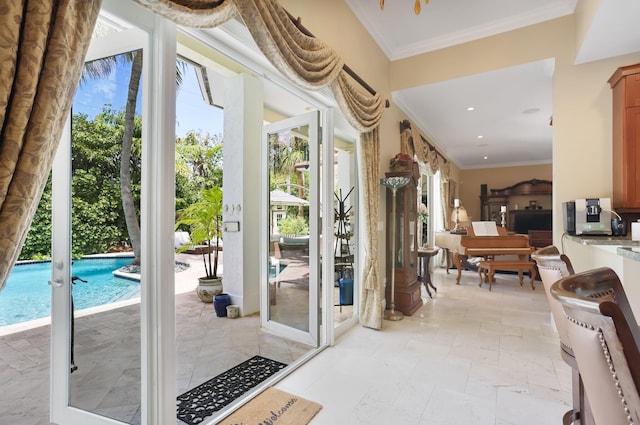 2409 NE 12th St, Fort Lauderdale, FL 33304 - entryway featuring recessed lighting, stone tile floors, and crown molding