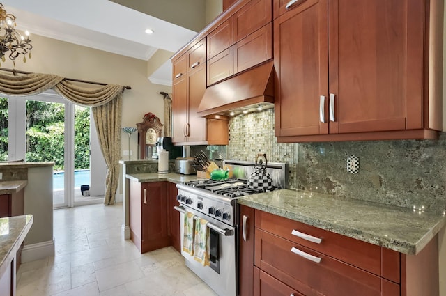 2409 NE 12th St, Fort Lauderdale, FL 33304 - kitchen with tasteful backsplash, light stone countertops, high end stove, and custom range hood