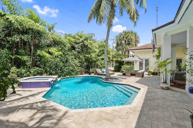 2409 NE 12th St, Fort Lauderdale, FL 33304 - view of pool featuring outdoor lounge area, a patio area, and a pool with connected hot tub