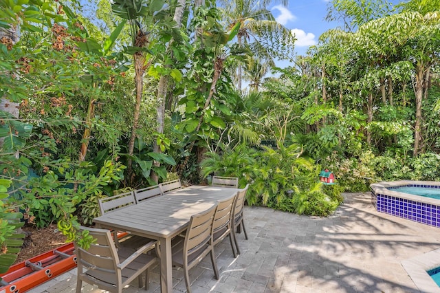 2409 NE 12th St, Fort Lauderdale, FL 33304 - view of patio with outdoor dining space and an in ground hot tub