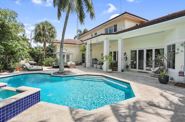 2409 NE 12th St, Fort Lauderdale, FL 33304 - view of swimming pool featuring an outdoor hangout area, a pool with connected hot tub, and a patio