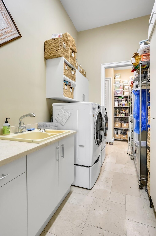 2409 NE 12th St, Fort Lauderdale, FL 33304 - washroom featuring stone tile flooring, washer and dryer, cabinet space, and a sink