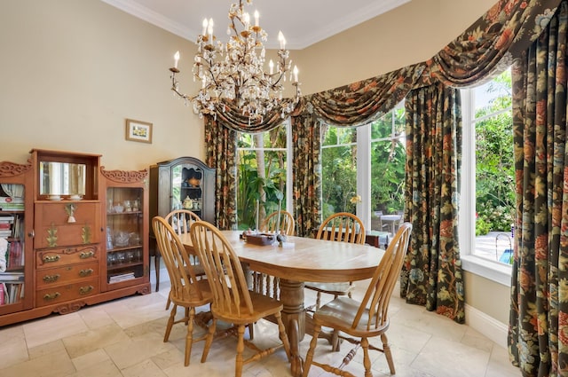 2409 NE 12th St, Fort Lauderdale, FL 33304 - dining space with plenty of natural light, crown molding, baseboards, and a notable chandelier