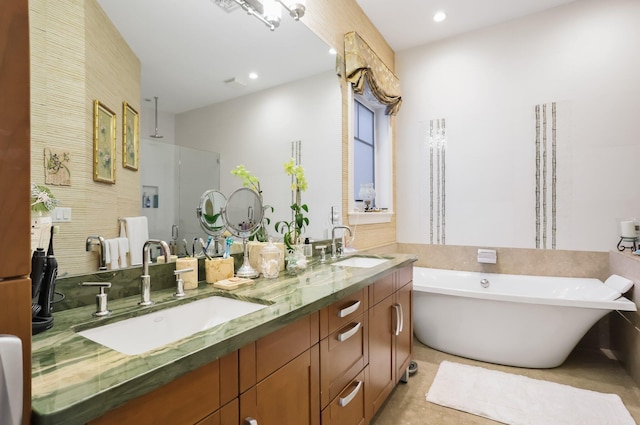 2409 NE 12th St, Fort Lauderdale, FL 33304 - full bathroom featuring a freestanding bath, double vanity, a shower stall, and a sink
