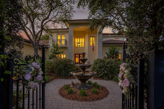 2409 NE 12th St, Fort Lauderdale, FL 33304 - view of front facade featuring stucco siding, a balcony, and a gate