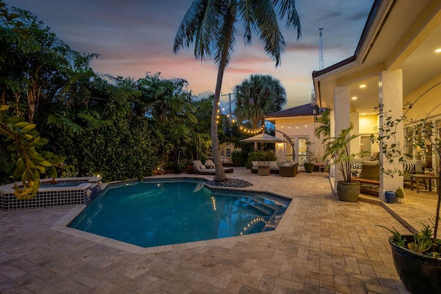 2409 NE 12th St, Fort Lauderdale, FL 33304 - view of swimming pool with outdoor lounge area, a pool with connected hot tub, and a patio